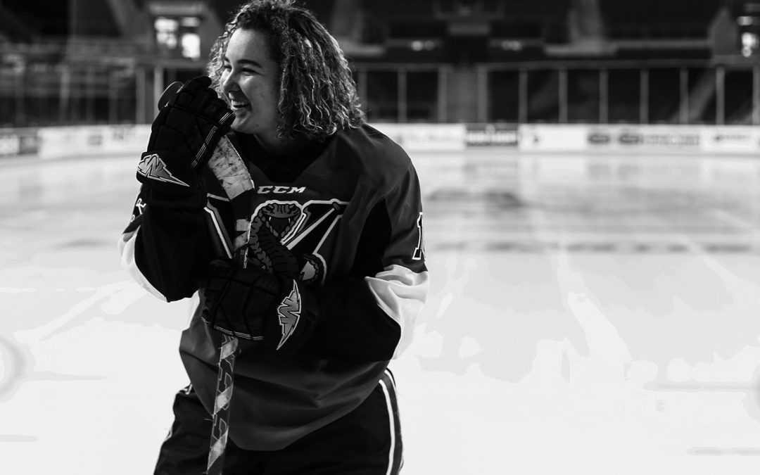 Girl laughs during hockey themed Erie senior portraits
