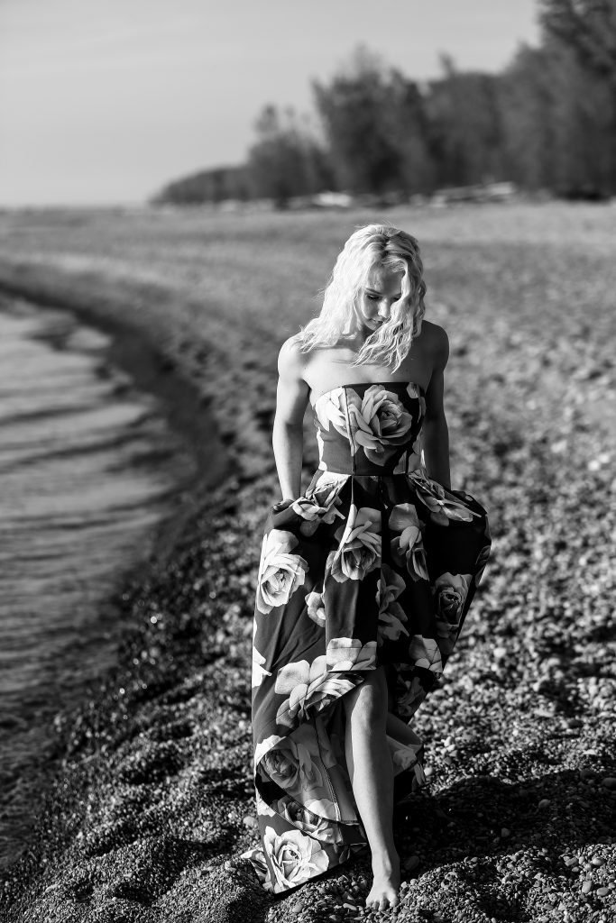 Girl in floral print dress walks along Beach One for Sweet Sixteen photos at Presque Isle