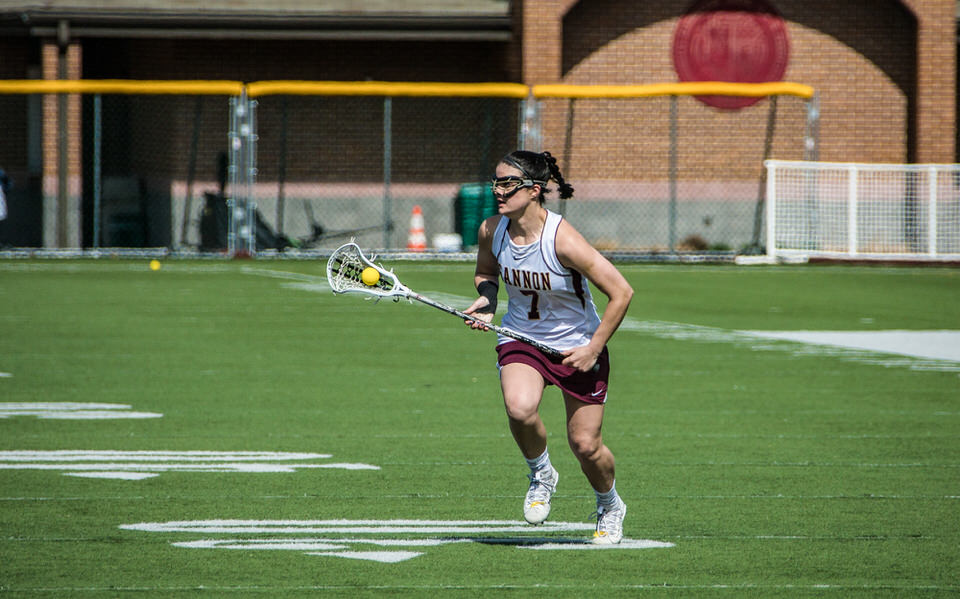 Gannon University's women's lacrosse player runs with ball