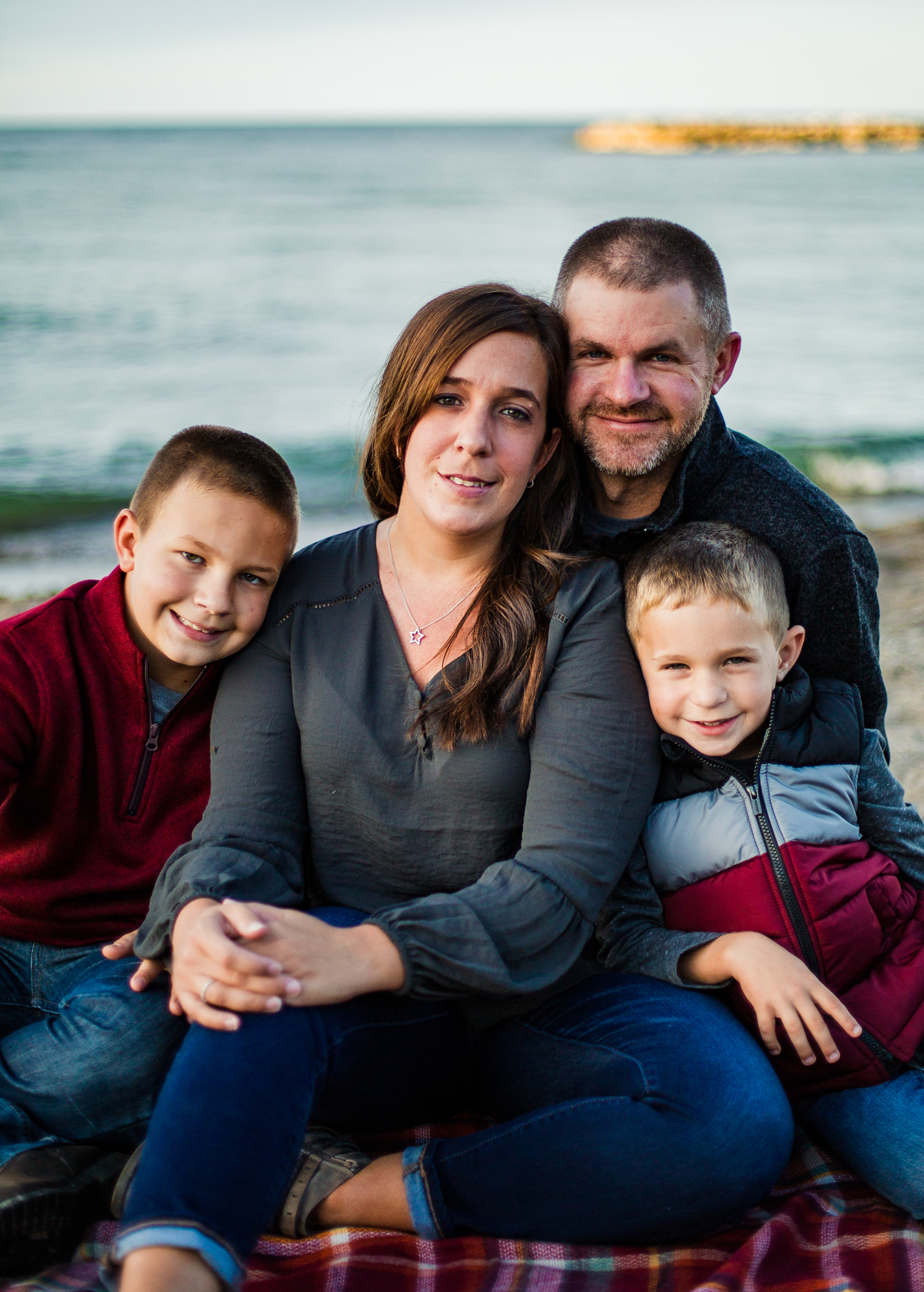 Family sitting on the beach for Presque Isle family portraits