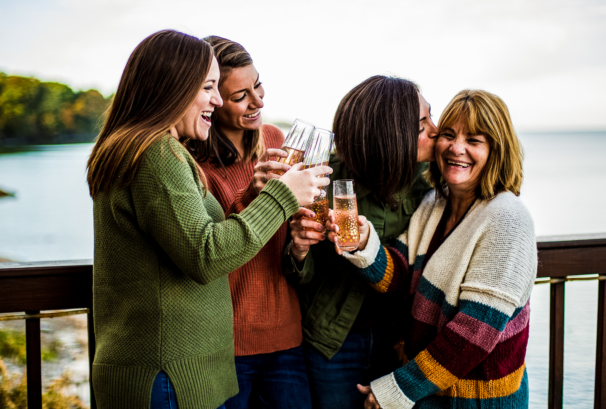 Mother and three daughters toast with champagne during family portraits in Erie, PA