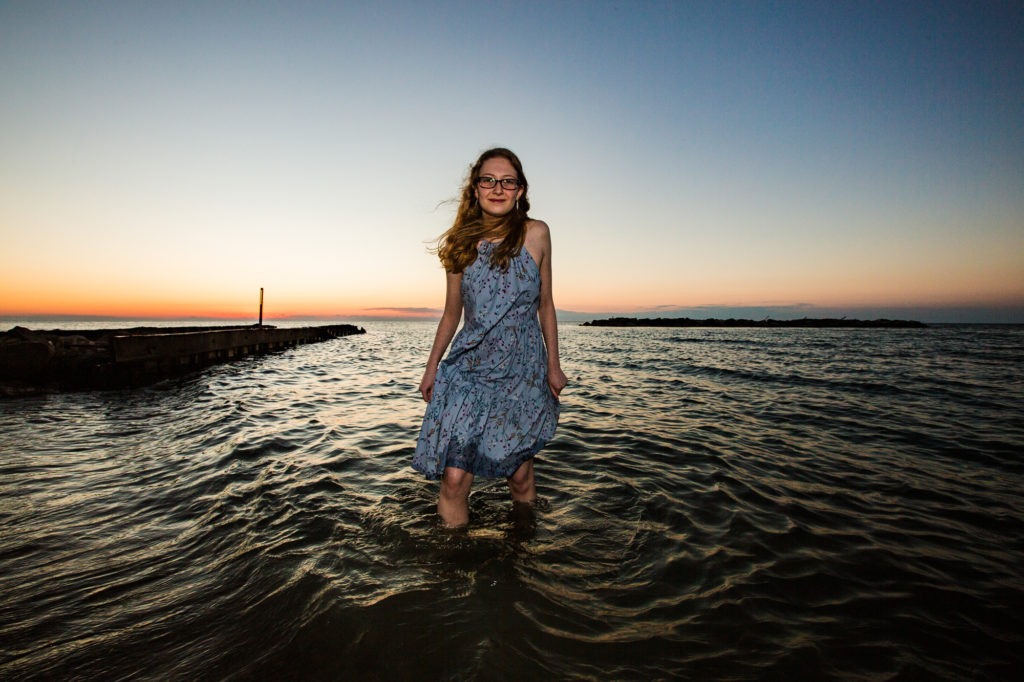 Girl wading in the lake for senior photos in Erie PA