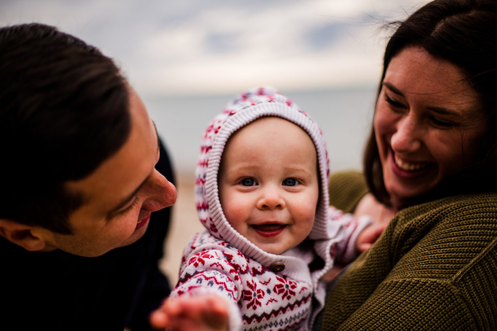 Baby reaches toward camera during family photos at Presque Isle