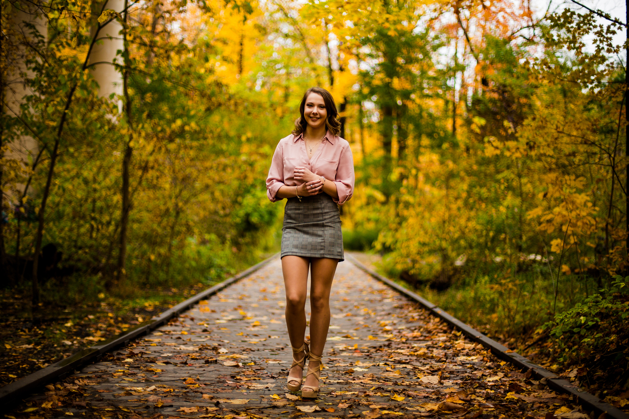 Senior girl walks a path during the fall at Wintergreen Gorge in Erie, PA