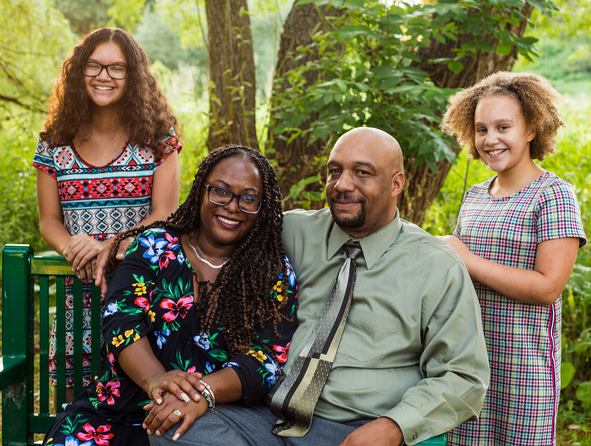 Man, woman, and two girls pose for family portraits at Frontier Park in Erie, PA