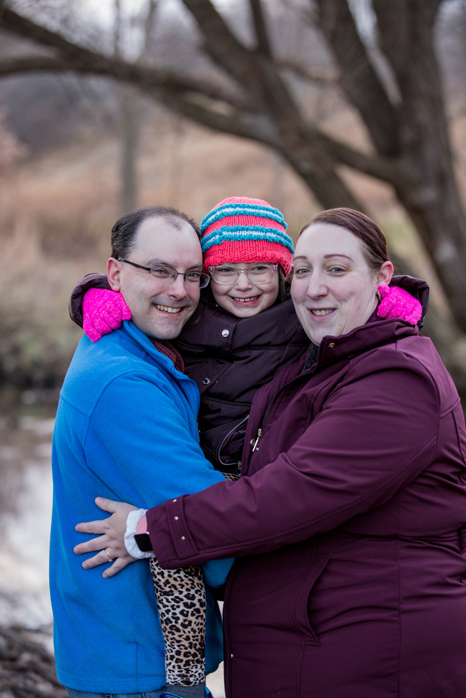 Mother,father and daughter embrace during family photos at Frontier Park in Erie, PA