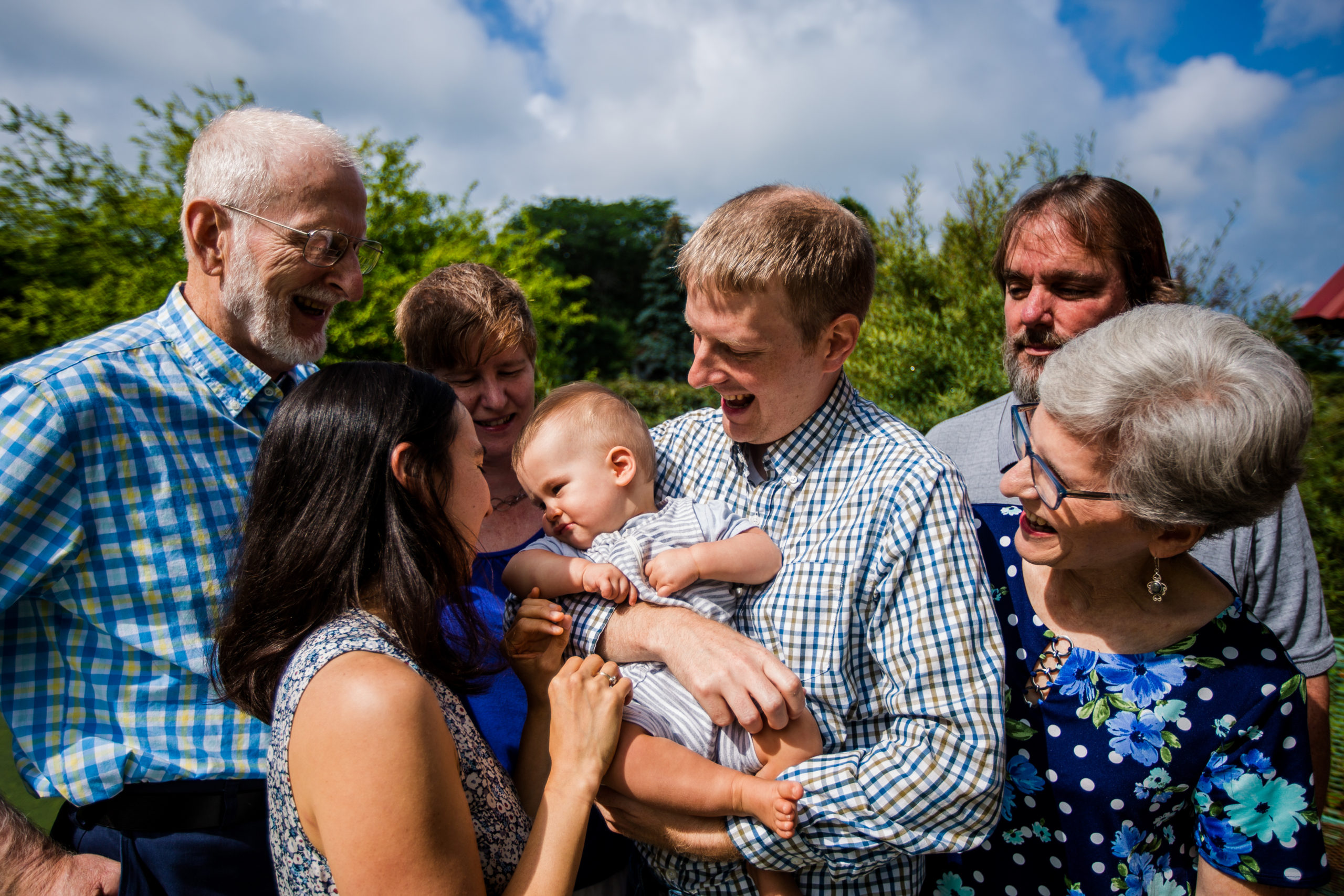 Family gathers around infant to celebrate grandparents' 50th wedding anniversary