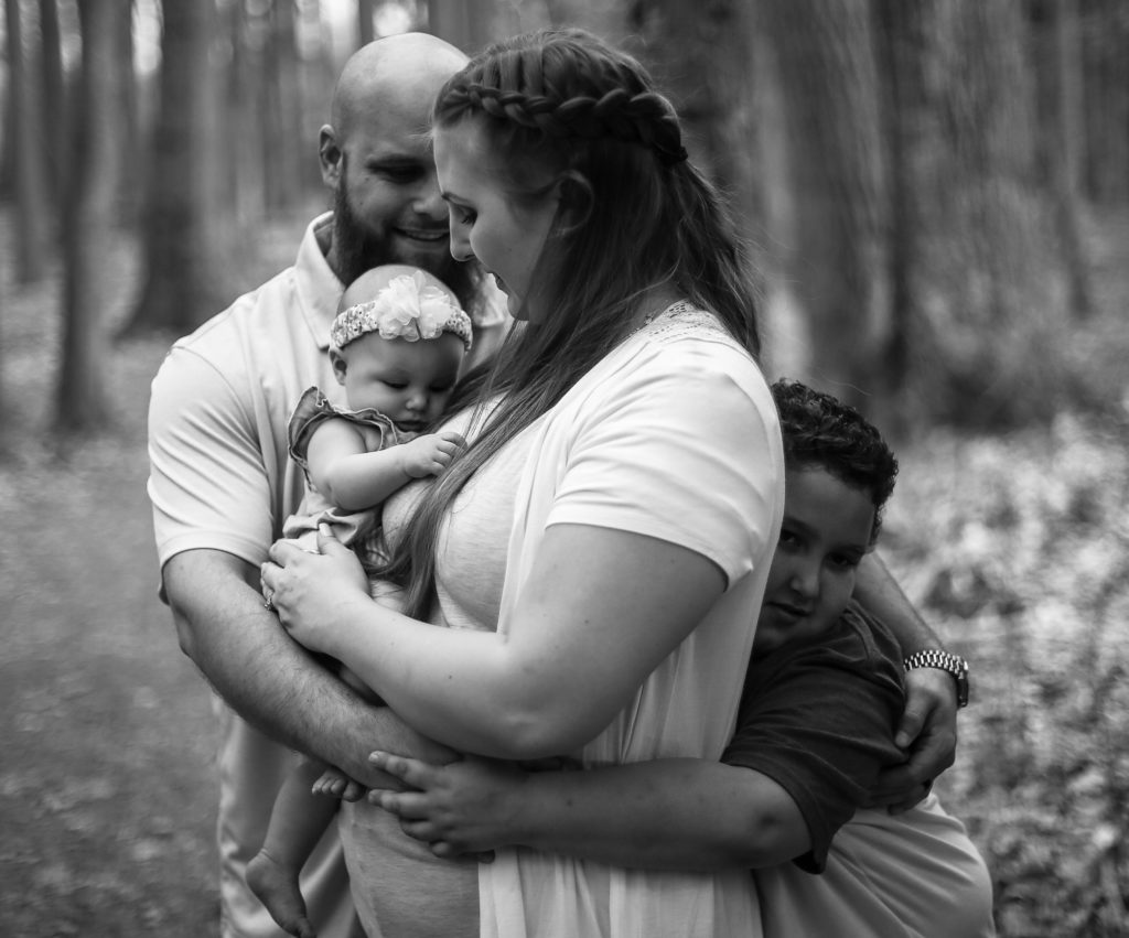 Family group hug during portraits at Asbury Woods