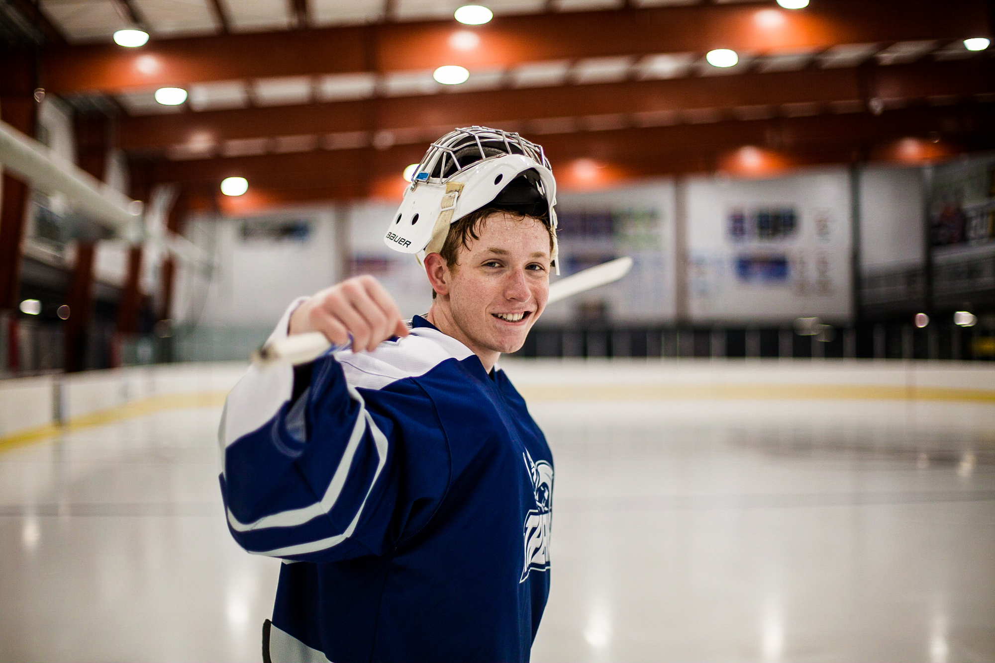 Senior photo of boy in hockey gear on the ice