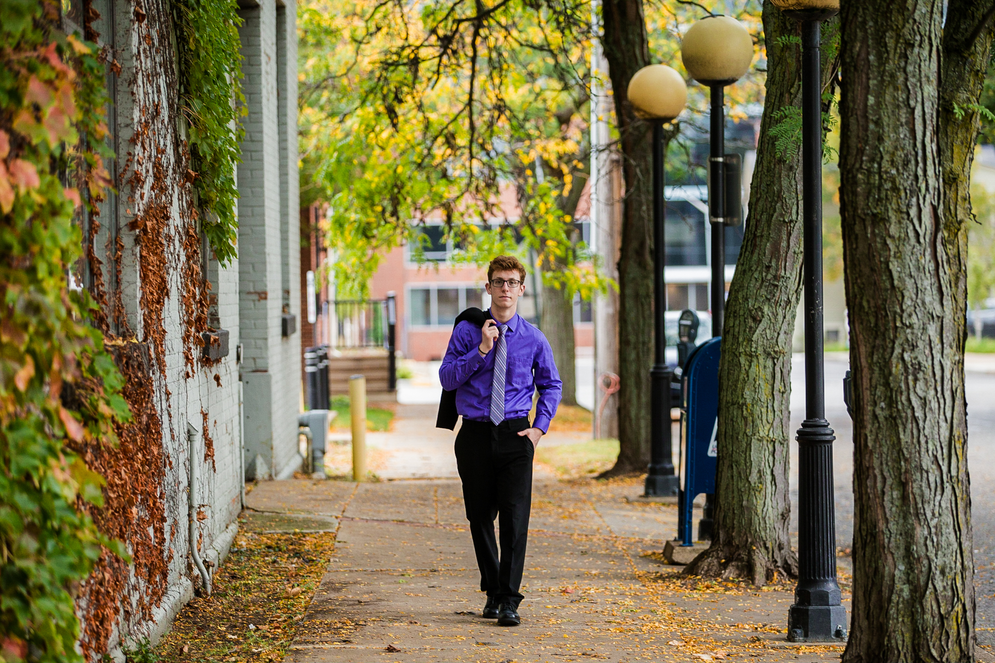 Senior boy walking down the street in Downtown Erie, PA