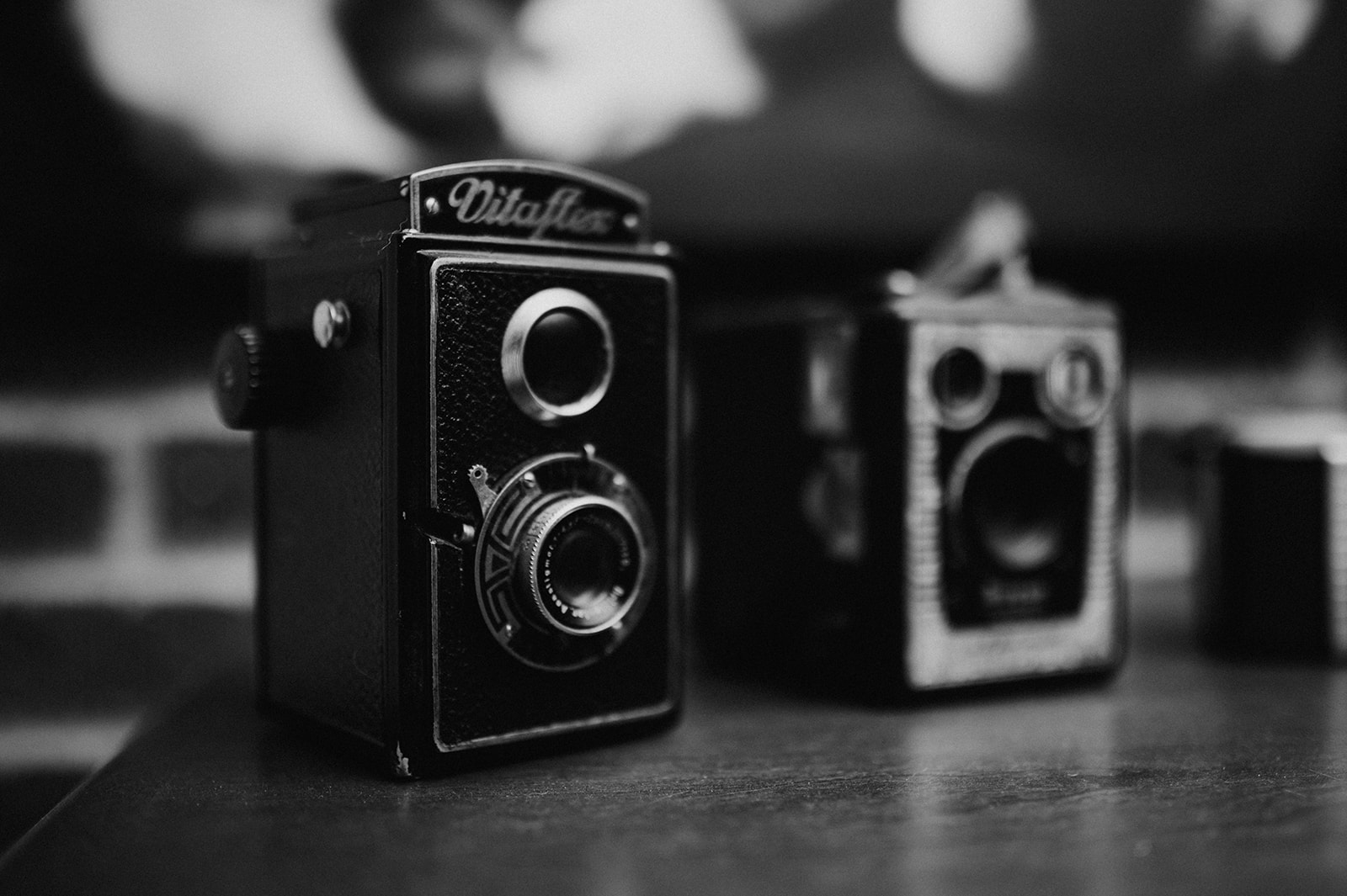 Two antique cameras in black and white.